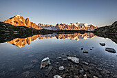 Mont Blanc range reflected at sunrise from the shore of Lac des Cheserys, Aiguilles Rouges, Chamonix, Haute Savoie, French Alps, France, Europe