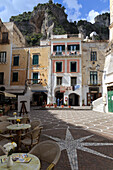 Town square with restaurant tables and colourful buildings, star shaped paving, Atrani, near Amalfi, Costiera Amalfitana (Amalfi Coast), UNESCO World Heritage Site, Campania, Italy, Europe
