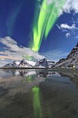 Northern Lights (aurora borealis) and mountains reflected in the cold waters, Skagsanden, Lofoten Islands, Arctic, Norway, Scandinavia, Europe