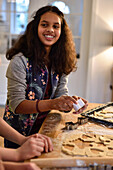 11 years old girls baking christmas cookies, cutting out dough, Hamburg, Germany