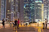 Night, Pudong, people on bridge, walkway, skyscraper, illuminated, office spaces, financial district, Shanghai, China, Asia