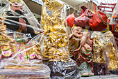 temple shop, figures, gods,  Buddhas wrapped in clear plastic, religion, superstion, decorations, Singapore