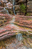 Water flows over a very colourful waterfall in the heart of Toro Toro National Park, Bolivia