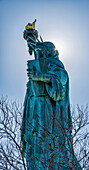 Sun shining behind Statue of Liberty torch, Liberty Island, New York City, New York, United States of America