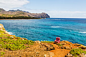 View of a red stuffed arm chair placed on a cliff edge, Poipu, Kauai, Hawaii, United States of America