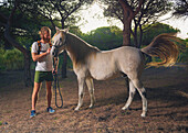 A man standing with a white horse, Cadiz, Andalusia, Spain