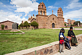 Aymara People Sitting On The Plaza In Front Of The 16Th Century Church, Laja, La Paz Department, Bolivia