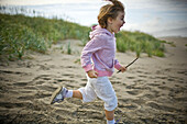Playful girl running on beach