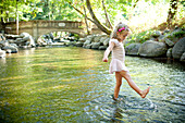 Girl splashing in park river