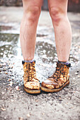 Caucasian woman wearing dirty boots