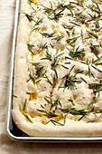Close up of focaccia dough with herbs