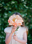 Close up of girl holding bouquet of flowers