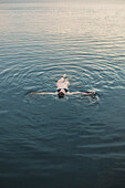 Caucasian woman floating in still lake