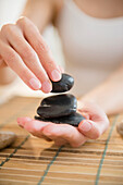 Mixed race woman holding massage stones