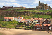 St. Mary's Church and Whitby Abbey above Tate Hill Beach, seen from West Cliff, Whitby, North Yorkshire, England, United Kingdom, Europe