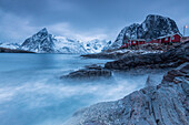 Dusk light on the typical red houses and rough sea, Hamnoy, Lofoten Islands, Northern Norway, Scandinavia, Arctic, Europe