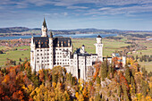 View of the castle Neuschwanstein from the mountains above the Marienbruecke in Autumn, Upper Allgaeu, Bavaria, Germany