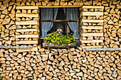 window framed with firewood, near Mittenwald, Upper Bavaria, Bavaria, Germany