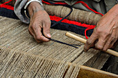 Women weaving on a simple weaving loom in Nar, Nepal, Himalaya, Asia