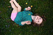 Caucasian girl laying in grass