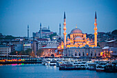 New Mosque Yeni Cami at night with Hagia Sophia Aya Sofya behind seen across the Golden Horn, Istanbul, Turkey, Europe