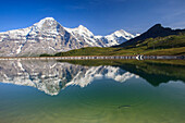 Mount Eiger reflected in clear waters of a lake, Mannlichen, Grindelwald, Bernese Oberland, Canton of Bern, Swiss Alps, Switzerland, Europe