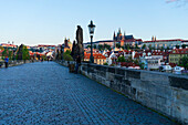 Early morning on Charles Bridge looking towards Prague Castle and Hradcany, UNESCO World Heritage Site, Prague, Czech Republic, Europe