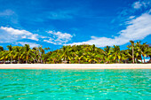 Clear turquoise water and white sand beach at Malcapuya Island