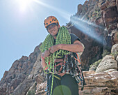 Climber Chad Cochran coils a rope at the top of a climb in Red Rocks, Nevada.