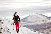 A backcountry skier skins along the snowfields on Burnt Mountain, Maine.