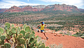 Woman runs the Cathedral Rock Trail in Sedona, Arizona May 2011. The trail over slick rock sandstone leads to a popular group of spires above Sedona.  Model Release: Agnes Hage