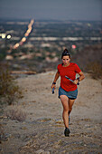 Woman trail running in South Mountain Park, Phoenix, Arizona November 2011.  The park overlooks the city of Phoenix.