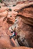 Josh Williams rappelling in Cassidy Arch Canyon, Capitol Reef National Park, Utah.