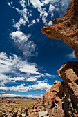 A young man plays on the rocks in the Atacama Desert. The Salar de Uyuni is the world's largest salt flat and home to one of the largest deposits of lithium in the world. The communities surrounding this region could potentially benefit greatly or suffer 