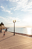 people walking at the waterfront of Porec, Istria, Croatia
