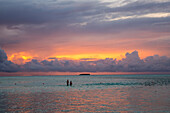 Zwei Badende im Wasser, Sonnenuntergang, Meeru Island Resort, Meerufenfushi, Nord-Male-Atoll, Malediven