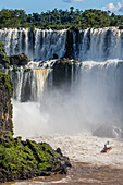 A river boat at the base of the falls, Iguazu Falls National Park, UNESCO World Heritage Site, Misiones, Argentina, South America