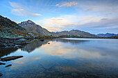 Peak Tambo reflected in Lake Bergsee at dawn, Chiavenna Valley, Spluga Valley, Switzerland, Europe