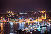 Istanbul at night, with Blue Mosque on left, New Mosque on right and Galata Bridge across Golden Horn, Turkey, Europe