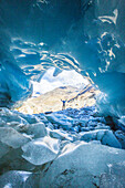 Hiker inside Forni Glacier, Forni Valley, Stelvio National Park, Valtellina, Lombardy, Italy, Europe
