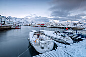 The typical fishing village of Henningsvaer surrounded by snow capped mountains and the cold sea, Lofoten Islands, Arctic, Norway, Scandinavia, Europe