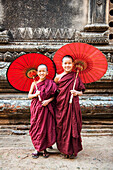 Two young monks and traditional umbrellas, Bagan Pagan, Myanmar Burma, Asia