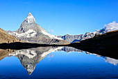 Hikers admiring the Matterhorn reflected in Lake Stellisee, Zermatt, Canton of Valais, Pennine Alps, Swiss Alps, Switzerland, Europe