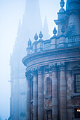 Radcliffe Camera and St. Mary's Church in the mist, Oxford, Oxfordshire, England, United Kingdom, Europe
