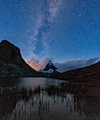 Stars and Milky Way above the Matterhorn reflected in Lake Stellisee, Zermatt, Canton of Valais, Swiss Alps, Switzerland, Europe