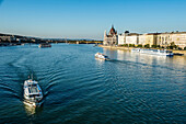 Little ferries on the River Danube in front of the Panorama of Pest, Budapest, Hungary, Europe