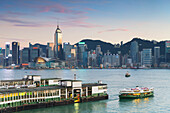 View of Star Ferry Terminal and Hong Kong Island skyline at dusk, Hong Kong, China, Asia