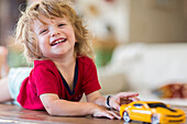 Caucasian boy playing with toy car
