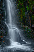 Waterfall flowing over rocky cliff