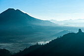 Mountains and morning fog in remote landscape, Kintamani, Bali, Indonesia